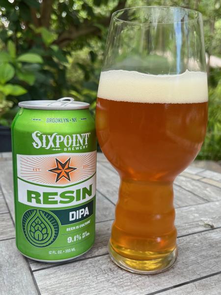 Can of Six Point Resin beer beside an amber liquid-filled glass.